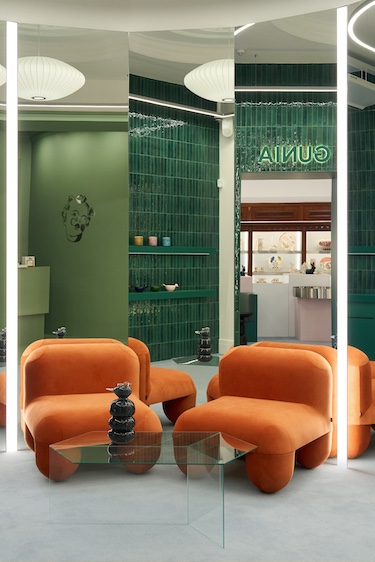 gunia project kyiv retail store lifestyle accessories ceramics ukrainian wood orange sculptural chairs glass side table mirrors green vertical subway tile