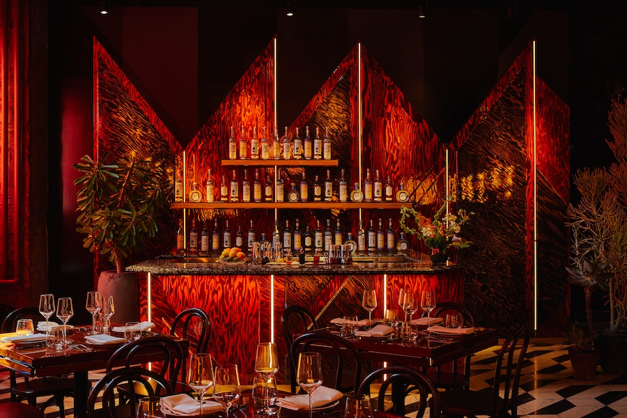 quality branded limusina new york midtown manhattan dramatic cinematic blade runner retro futurism red curtains amber ambe lights black and white tiles gold chandelier bar