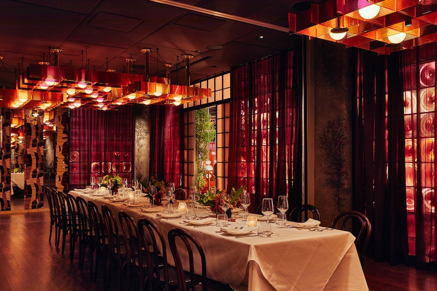 quality branded limusina new york midtown manhattan dramatic cinematic blade runner retro futurism red curtains amber ambe lights black and white tiles gold chandelier communal table