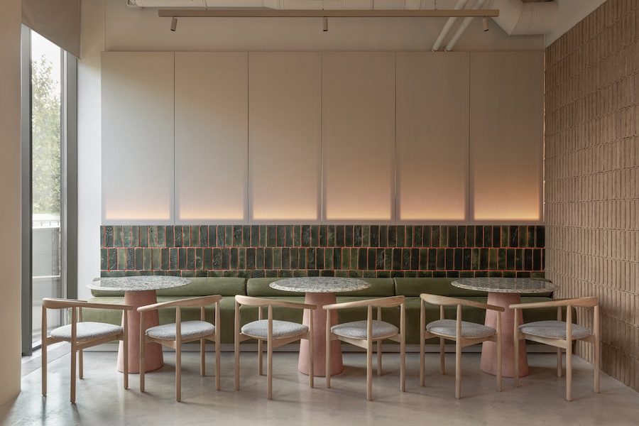 strichka kyiv ukraine green tiles green banquette black wood tables chairs pink pedestal table light oak chairs white columns exposed pipes