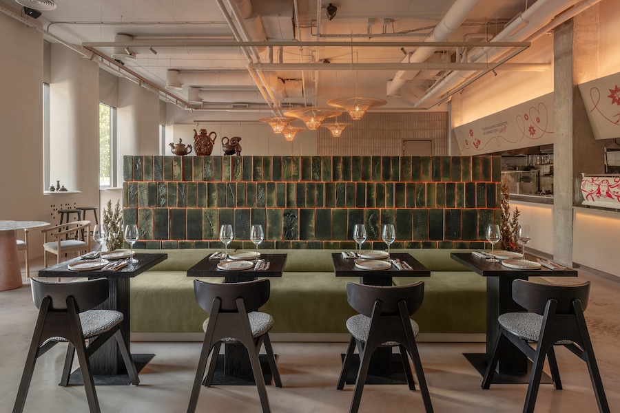 strichka kyiv ukraine green tiles green banquette black wood tables chairs pink pedestal table light oak chairs white columns exposed pipes