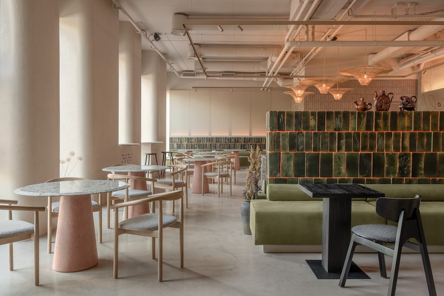 strichka kyiv ukraine green tiles green banquette black wood tables chairs pink pedestal table light oak chairs white columns exposed pipes