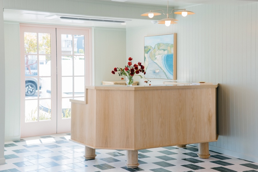 Bay Shores Hotel newport beach california coastal design lobby green white checkerboard floor oak reception desk white wainscoting