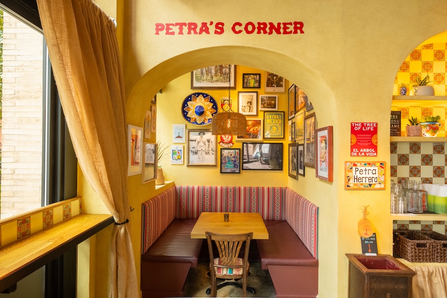 San Patricios jersey city pub cantina mexican irish design yellow walls curtains patterned tables wall art prints arched doorway private nook banquette