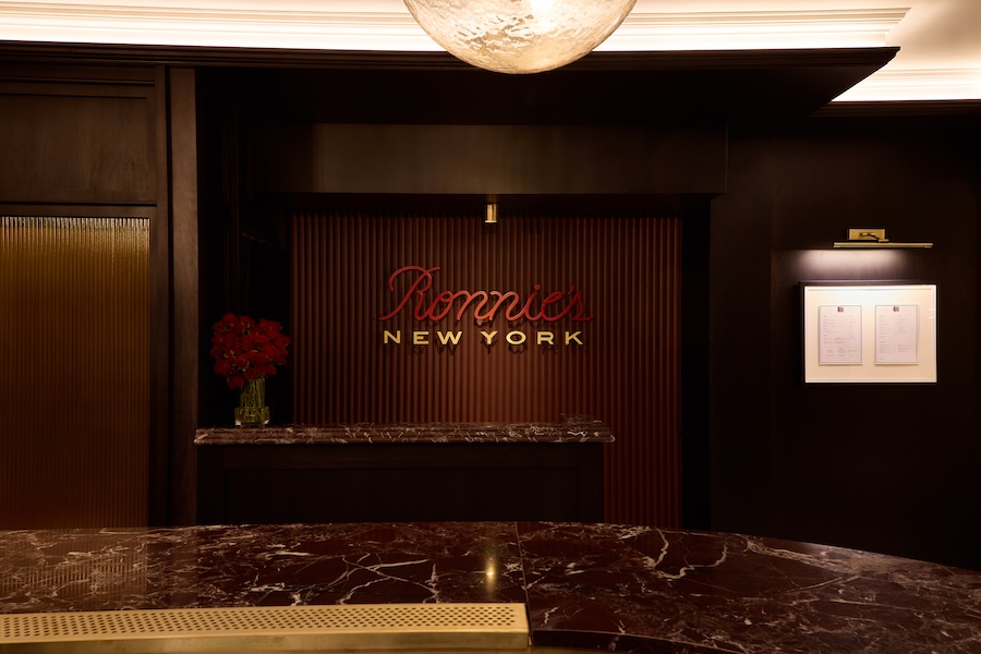 Ronnie's New York in London Regent street reception area wine red rosa lepanto marble millwork fluted wood