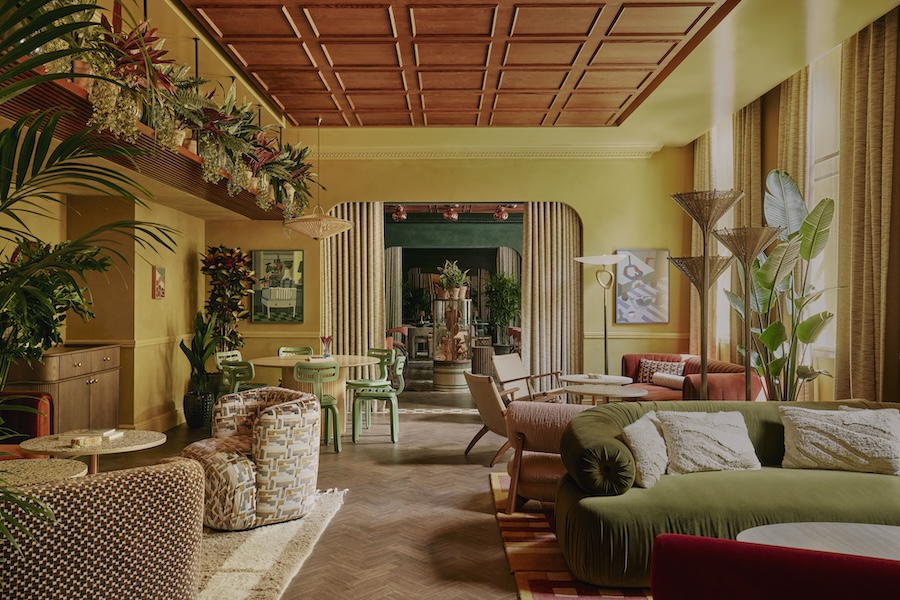 ember locke hotel west london kensington art deco colorful indoor plants parlor green sofa chairs yellow paint paneled ceiling