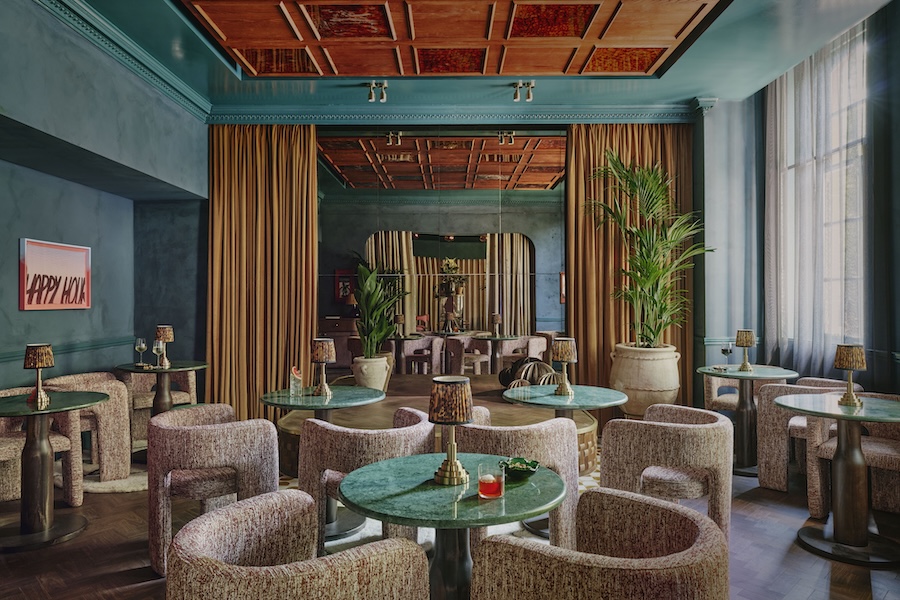 ember locke hotel west london kensington art deco colorful indoor plants teal paint paneled ceiling rounded dining chairs emerald green table tops