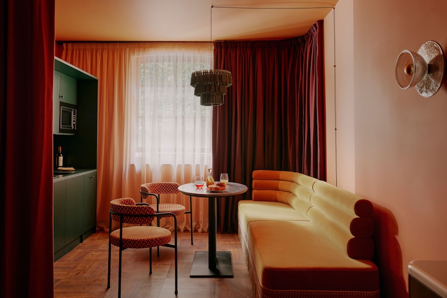 ember locke hotel west london kensington art deco colorful indoor plants brown velvet rolled banquette green cabinet red curtains