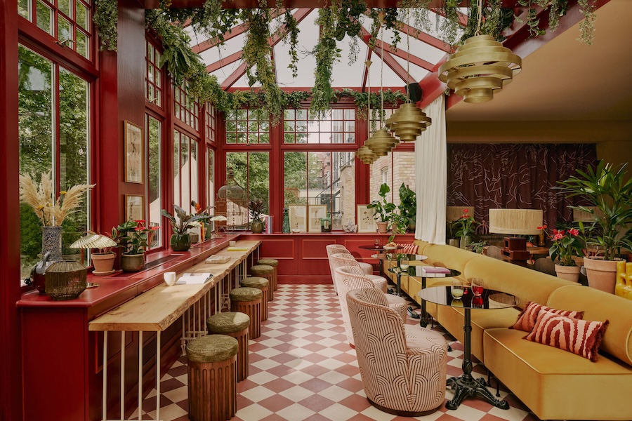 ember locke hotel west london kensington art deco colorful indoor plants restaurant yellow banquette red white pattern swivel chairs red paint bar red white checkerboard flooring