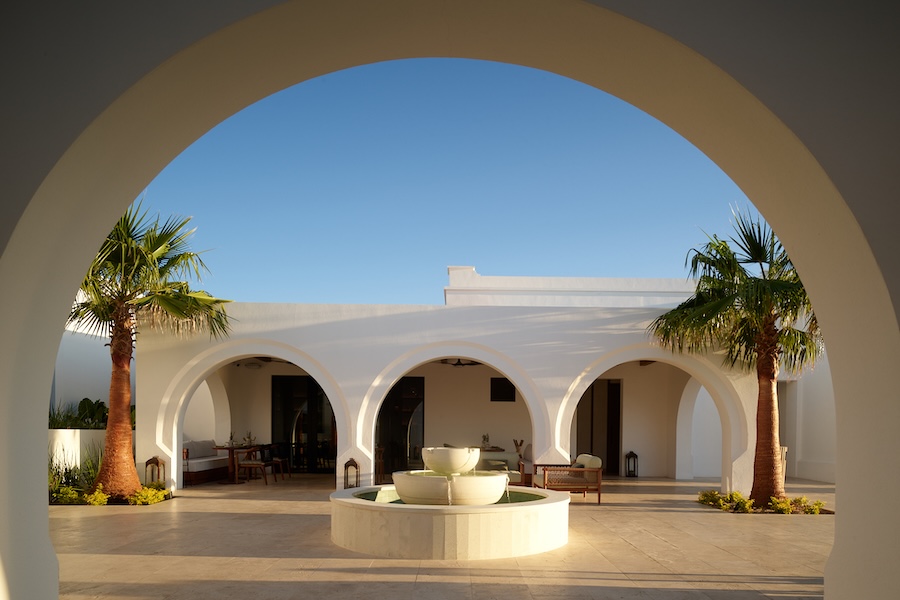 one&only palmilla social club white arches coastal palm trees fountain