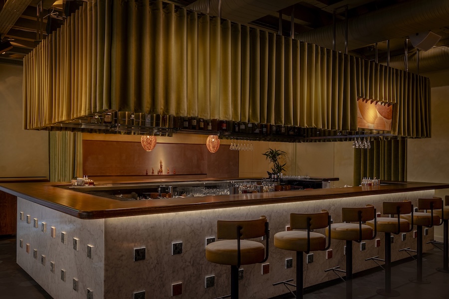 anise bar at cinnamon kitchen london devonshire square former east india trading company monolithic bar marble velvet green curtains leather bar stools