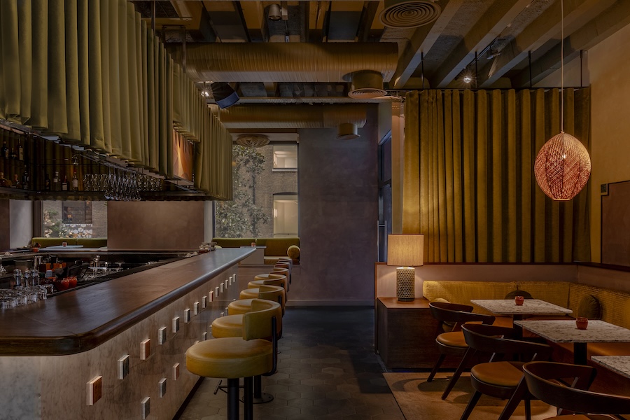 anise bar at cinnamon kitchen london devonshire square former east india trading company monolithic bar marble velvet green curtains leather bar stools